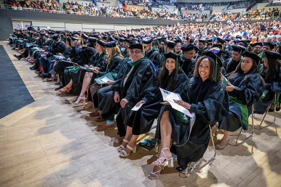 Group of young adults sitting at 2022 Hooding
