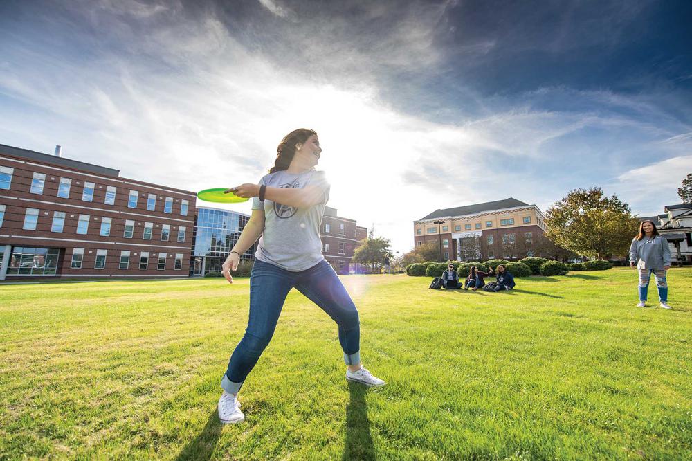 Augusta University students playing frisbee