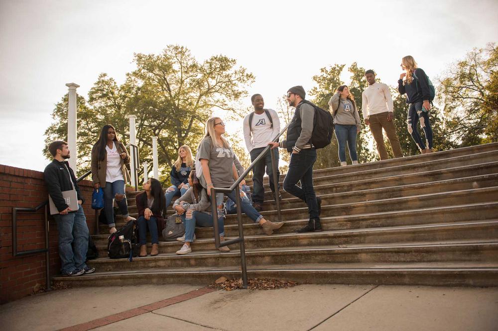 Augusta University Students talking on campus stairs
