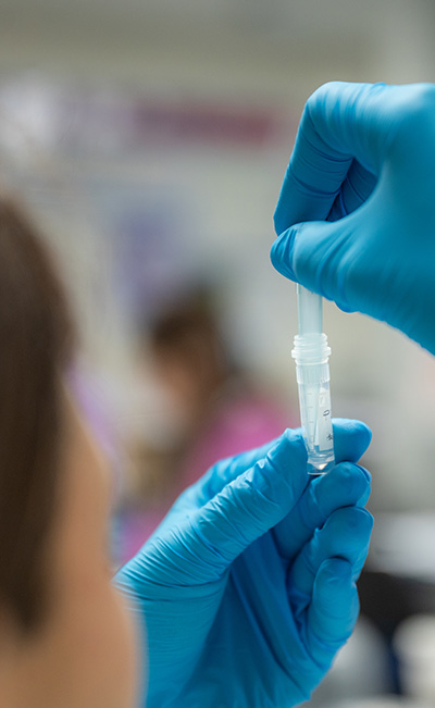 Student holding sample