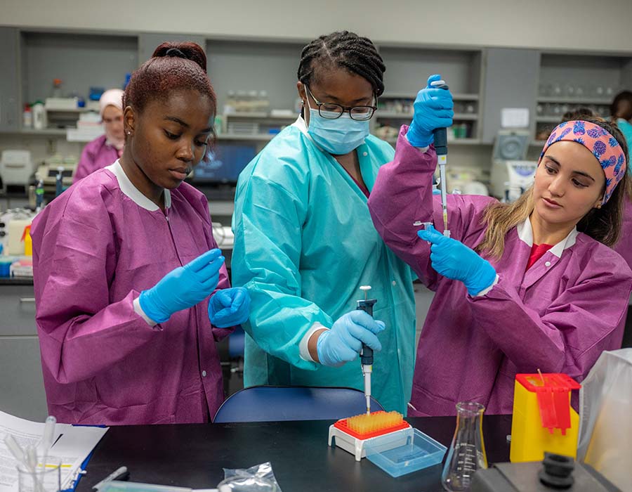 three students working in lab