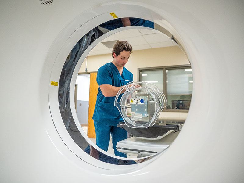 Student with radiation therapy machine