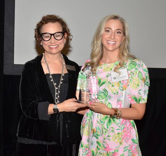 Lauren Bursey accepting the 2025 Outstanding Young Alumni  award