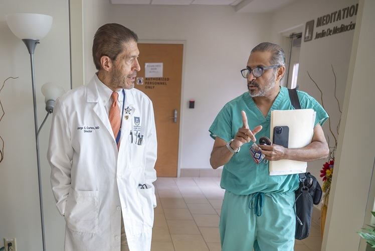 Dr. Cortes with faculty member walking down the hall