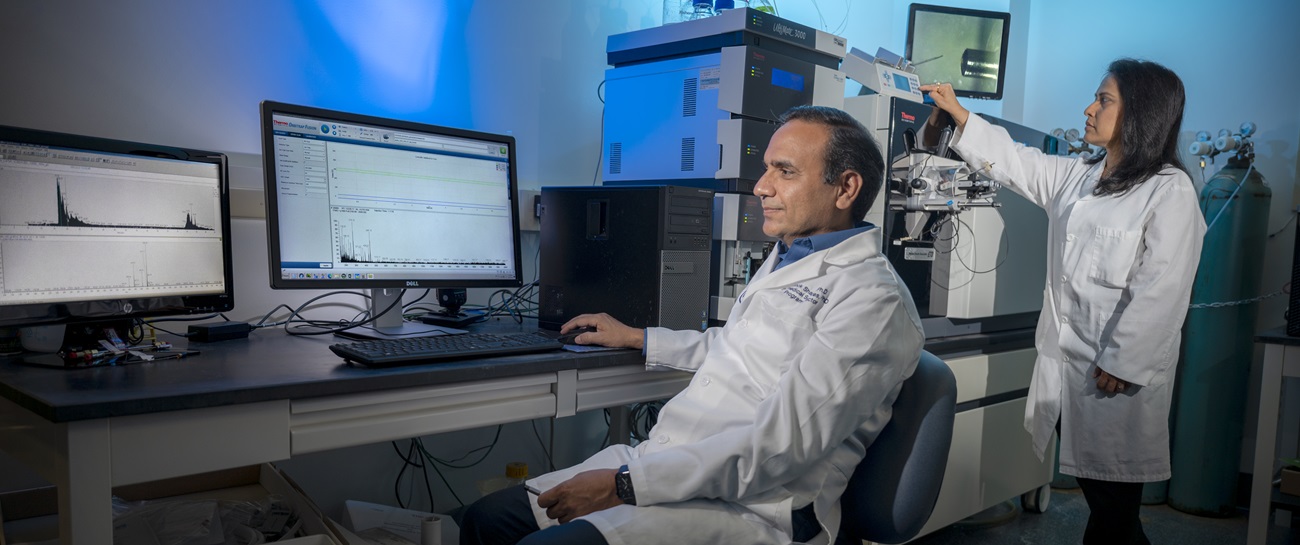 Dr. Shruti Sharma & Ashok Sharma working in lab