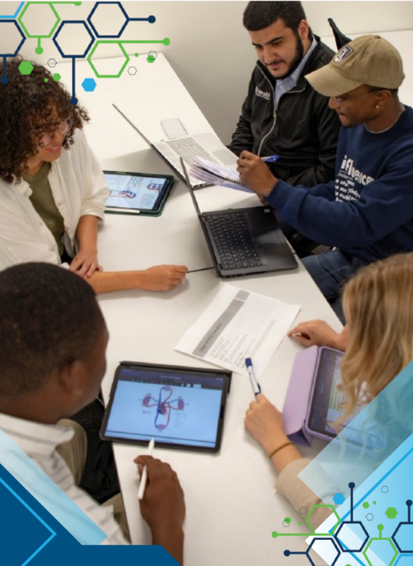 Students working at a desk together.