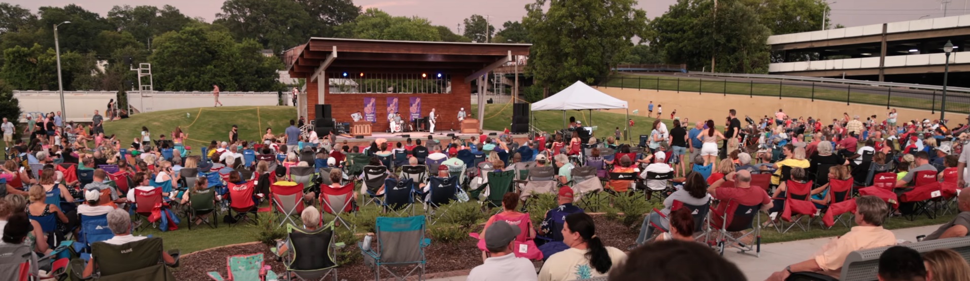People gathered at an open stadium listening to music