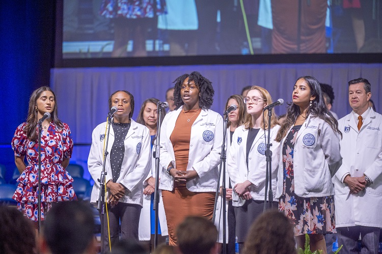 Group of young adults singing at White Coat Class of 2027