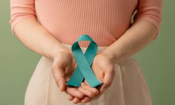 Women holding teal ribbon that represents gynecological cancer