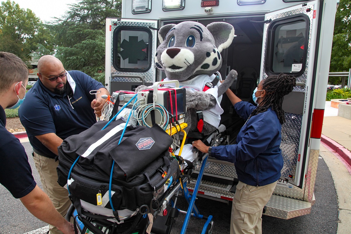 CHOG cc team with mascot and ambulance