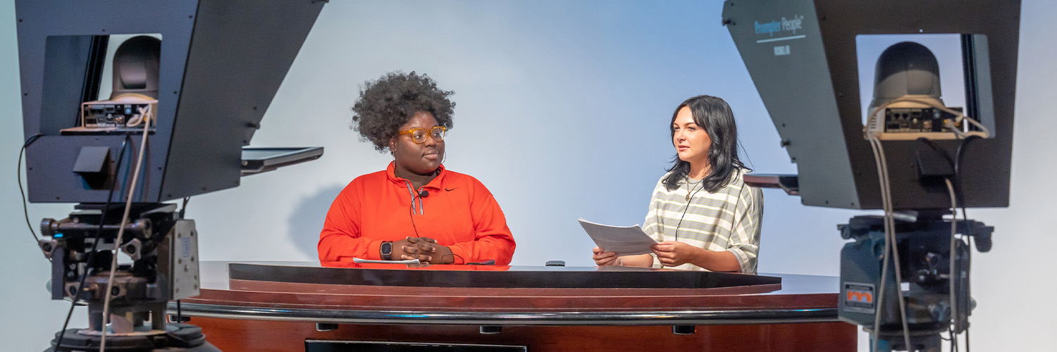 Communication students sitting in a video recording studio