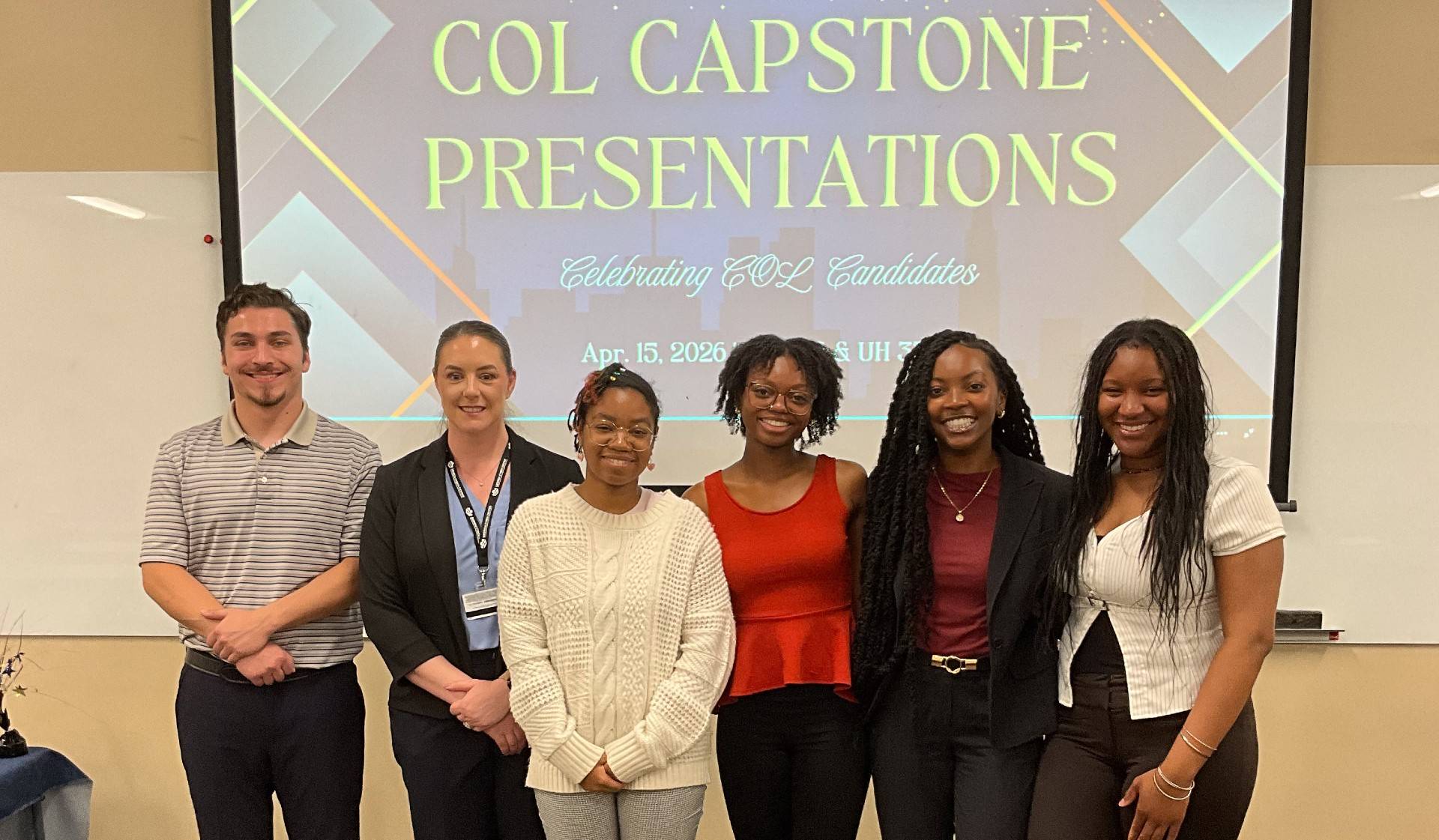 group of students standing in front of a screen