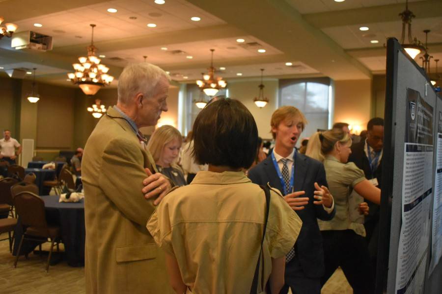 male student speaking to group of people