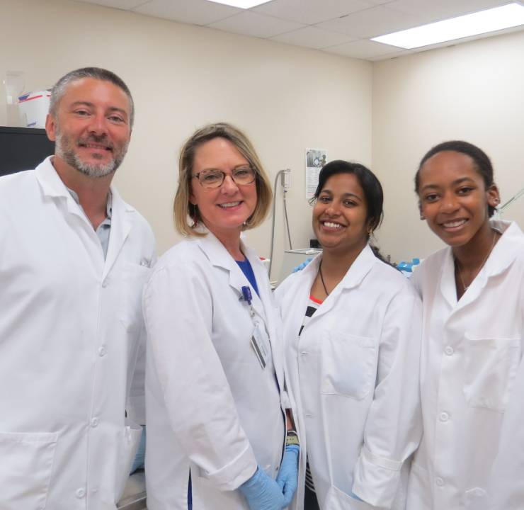 group of four people standing together