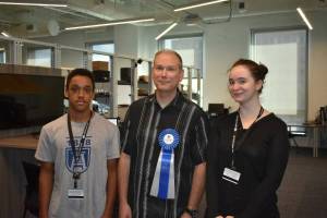 three people standing together in a lab
