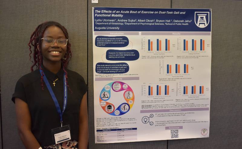 woman standing next to poster