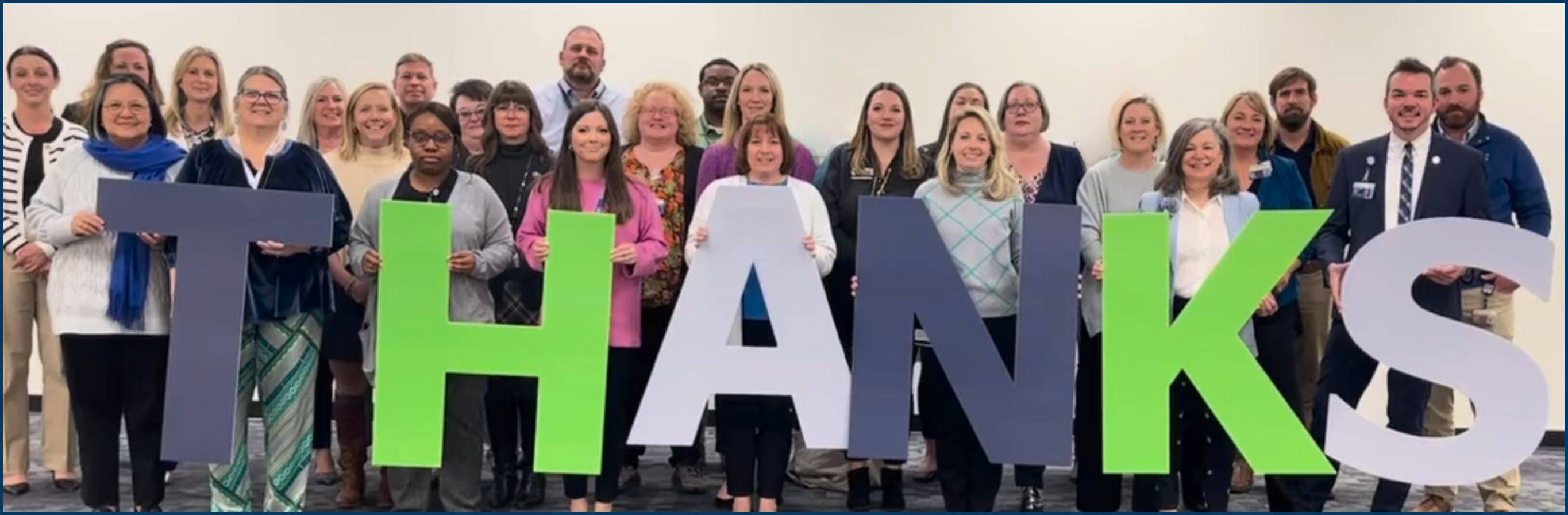 Philanthropy & Alumni Engagement staff holding up letters that spell out "thanks"