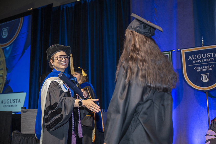 woman extending hand to a student