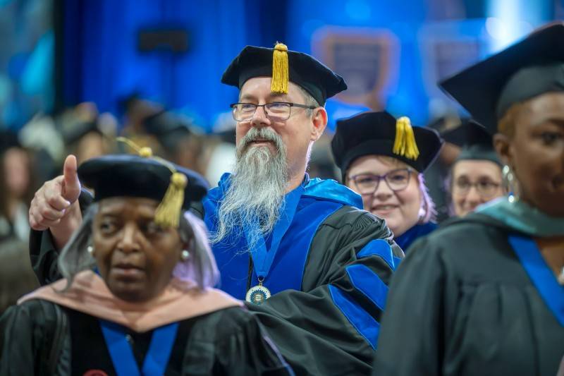 Man with a beard giving a thumbs up