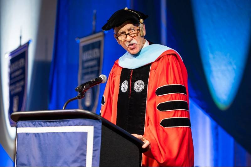 man speaking at podium