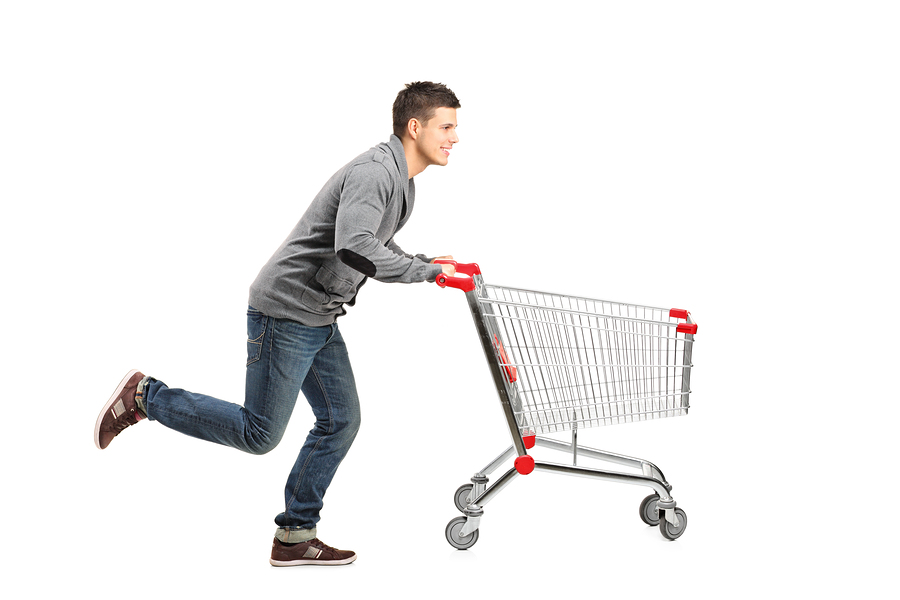 Man running behind a shopping cart