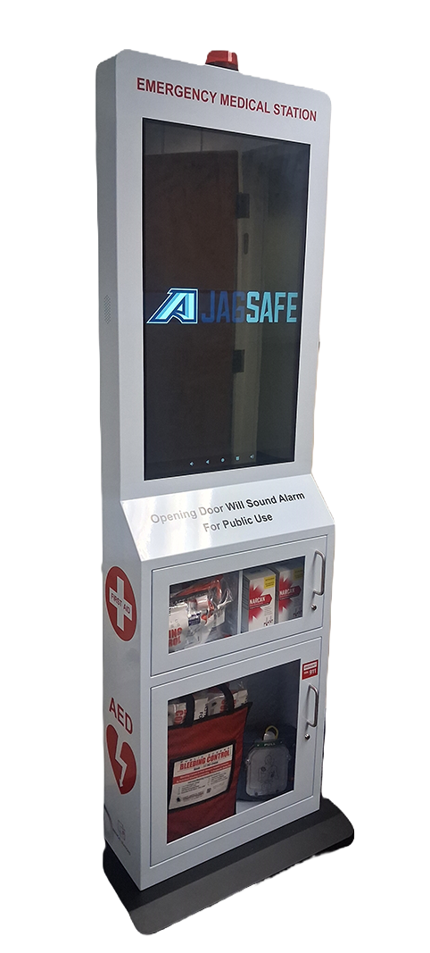 Shows a tall grey Emergency Medical Kiosk available on campus for public use. Has an interactive screen and alarm that activates when you have an emergency situation.