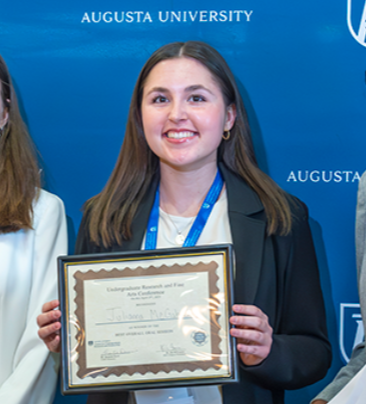 Julianna McGahee holding certificate