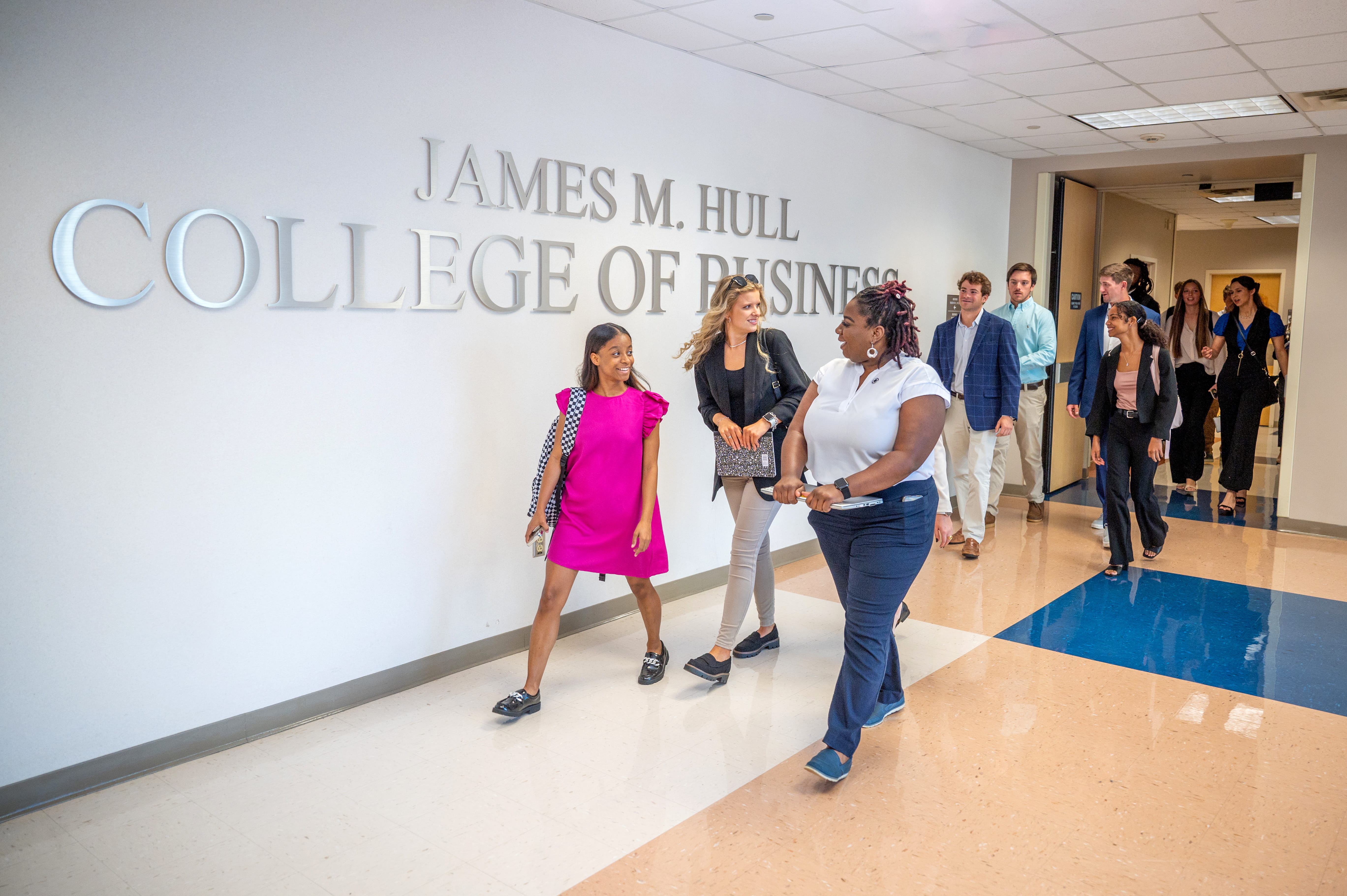 Students walk through a hallway and the Hull College of Business on Augusta University's campus