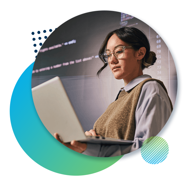 Woman in glasses studying data analytics on her laptop