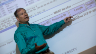 professor pointing at whiteboard