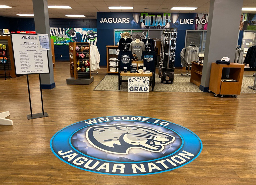 RoarStore welcome sign with merchandise in background