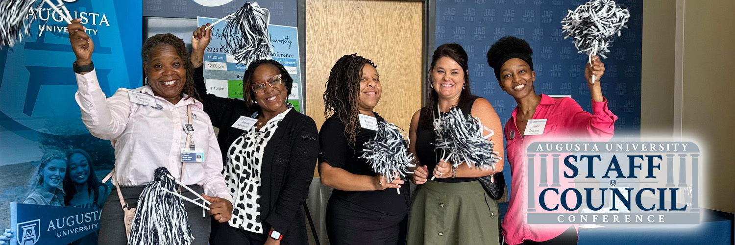 Photo of several AU staff members posing together