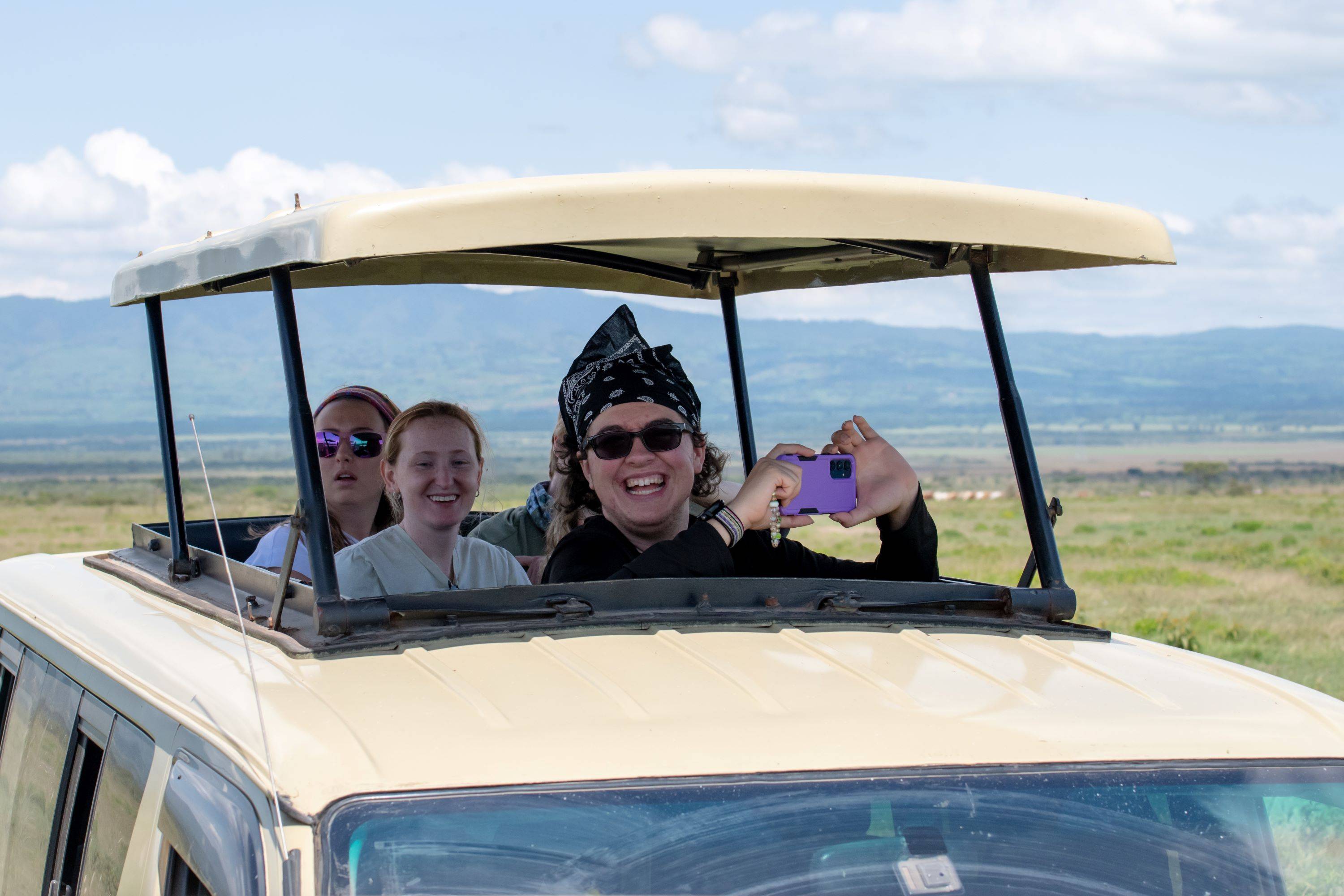 group of people in a vehicle safari